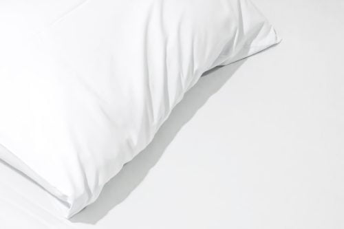Close up of bedding sheets with copy space,White pillow on the bed with blanket. percale shams